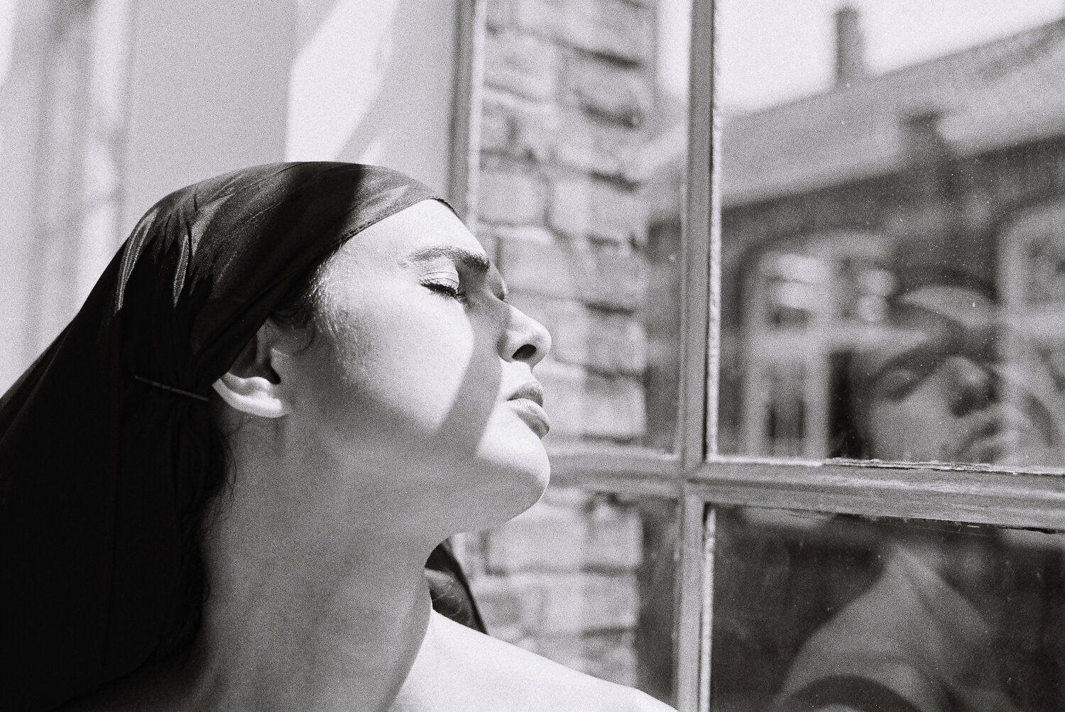 portrait, window, monochrome, blackandwhite, contemplative, introspective, profile, feminine, urban, natural, light, shadow, contrast, mood, emotion, Rozman Erik