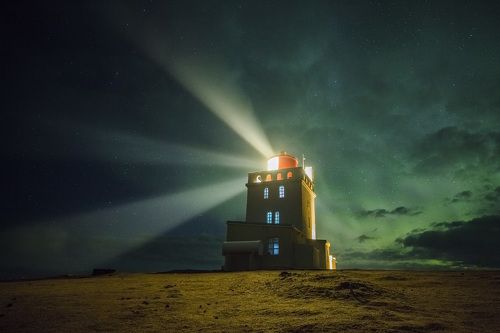 Lighthouse in green clouds. Iceland