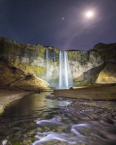 Midnight sun over Seljalandsfoss. Iceland.