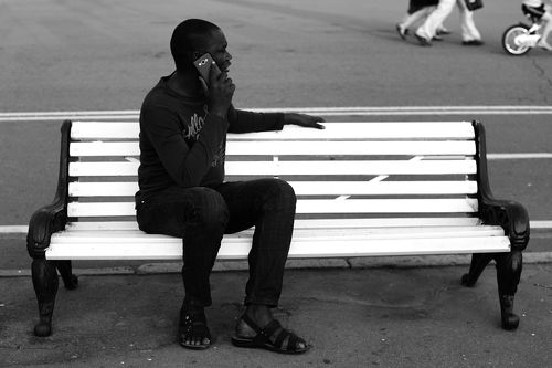 Black man on white bench