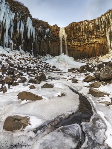 Winter sun touching Svartifoss. Iceland.