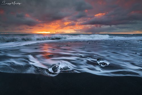 Curly waves just before sunrise. Diamond beach. Iceland.