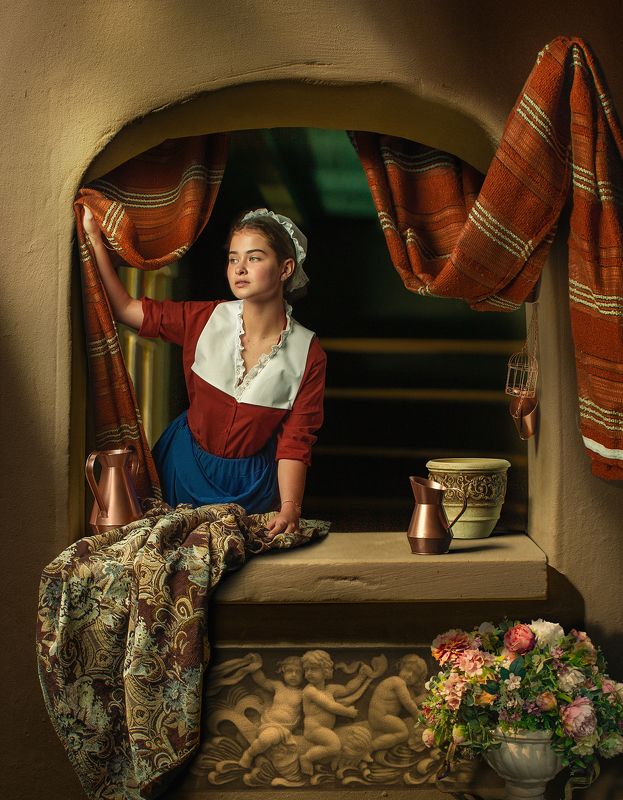 A young girl at a window ledge  фото превью