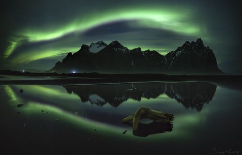 Northern lights, reflection and Vestrahorn. Iceland.