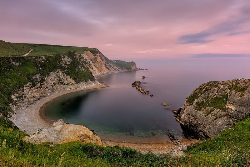Dorset coast, North Sea, UK, long exposure, sunset, Jurassic coast, summer Soft sunset and light pink haze above Man O\' War Beach. Dorset coast.  фото превью